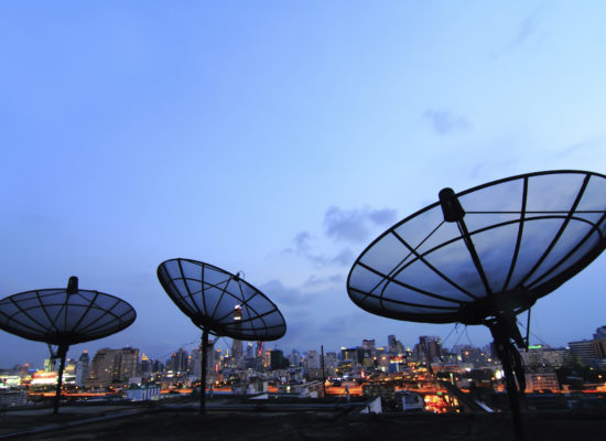 black antenna communication satellite dish over sunset sky in ci